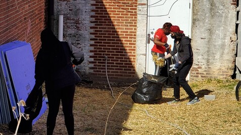 members of the team cleaning up behind We Act Radio